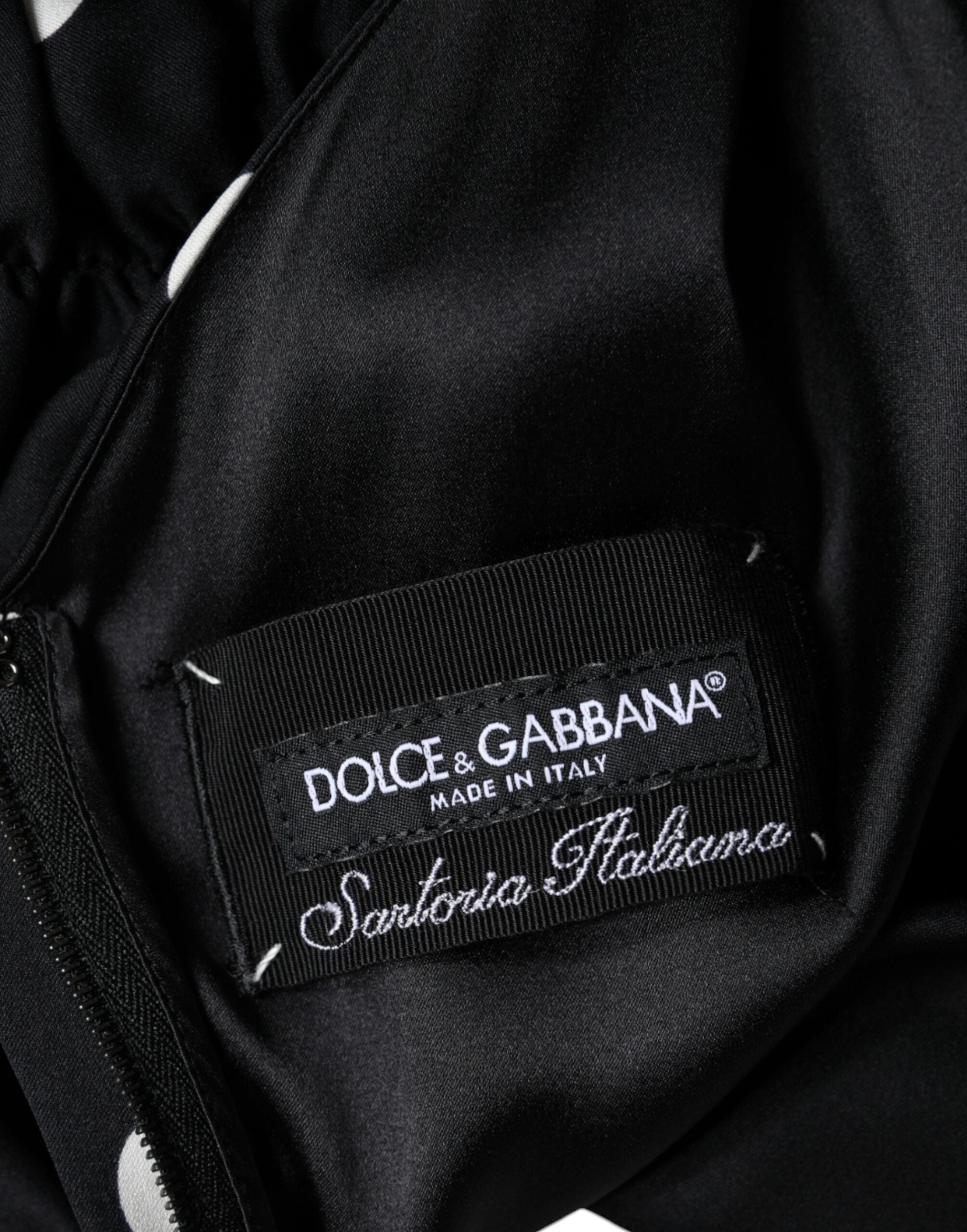 Dolce & Gabbana Schwarzes gepunktetes Midikleid aus Seide mit V-Ausschnitt und Quasten